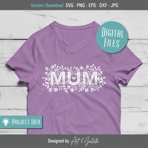 May include: A purple t-shirt with a white floral design and the word "MUM" with a small heart in the middle of the "U".