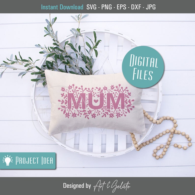 May include: A white pillow with the word "MUM" in pink letters surrounded by pink floral designs. The pillow is sitting on a white wicker tray.