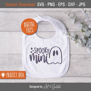 May include: White baby bib with a ghost and the text "SPOOKY mini" in purple.
