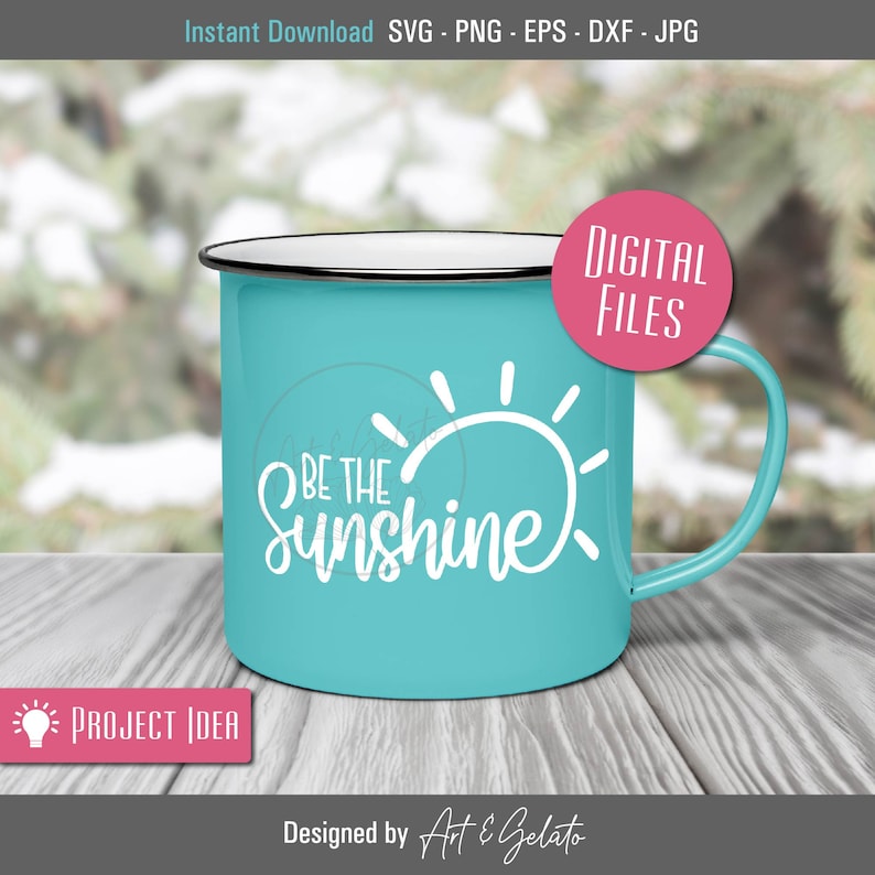 May include: A turquoise enamel mug with a white sun and the text "Be the Sunshine" on it. The mug is sitting on a wooden surface.