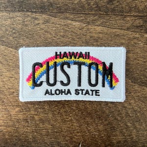 May include: White embroidered patch with a rainbow arch and the text "HAWAII CUSTOM ALOHA STATE".