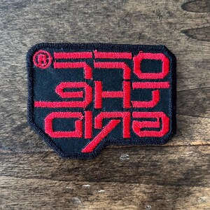 May include: Red embroidered patch with the text "1979" in a stylised font on a black background.