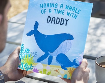 May include: A blue and white illustrated book with the text "Having a whale of a time with Daddy". The cover features a blue whale and a baby whale swimming in the ocean.