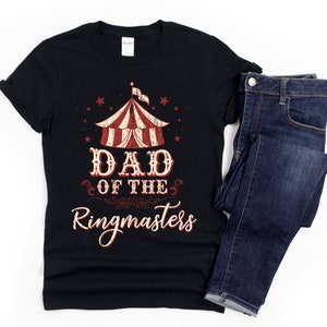 May include: Black t-shirt with a vintage circus tent graphic and the text "Dad of the Ringmasters".