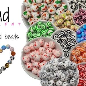 Bead Different logo with the words printed round beads 15mm wrote in black. Several small round display bowls filled with a wide ranged mixture of printed round beads.
