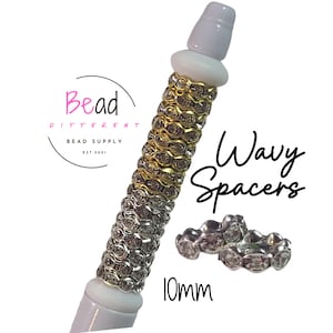 May include: A close-up of wavy spacers with a white base and a gold and silver design. The image includes the text "Wavy Spacers" and "10mm". The logo for "Bead Different Bead Supply" is also visible.