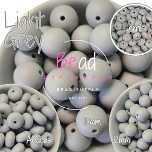 May include: Assortment of light gray silicone beads in three sizes: 12mm, 15mm, and lentil. The beads are in bowls and labeled "Abacus", "12mm", "15mm", and "Lentils".