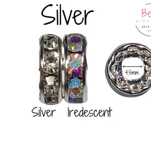 May include: Two silver spacer beads with clear and iridescent crystals. The beads are 10mm in diameter and have a 4.5mm hole. Bead Different Bead Supply est. 2021.