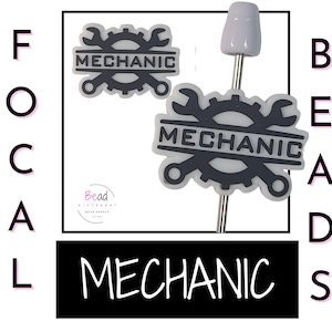May include: Two gray and black mechanic-themed beads. One bead is on a metal pin. The beads feature a wrench and gear design with the word "MECHANIC". The word "MECHANIC" is also displayed in a black rectangle.