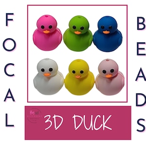 May include: Six 3D duck shaped beads in various colours: pink, green, blue, white, yellow, and light pink. The beads are arranged in two rows of three. The text "FOCAL BEADS" is on the left side of the image and "3D DUCK" is on the right side of the image.