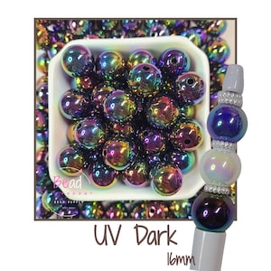 May include: A collection of iridescent UV dark beads in a white square bowl. The beads are a mix of purple, green, and gold. A sample bead is shown on a gray stick. The text "UV Dark" and "16mm" is visible.