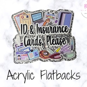May include: A silver glitter acrylic flatback featuring medical office illustrations including a laptop, telephone, and various identification cards. The text ID & Insurance Cards, Please is printed in black script across the center.