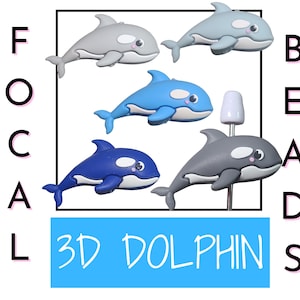 May include: Collection of 3D dolphin-shaped beads in various shades of blue, gray, and white. The beads have a cartoon-like design with a smiling face. The text "3D DOLPHINS" is displayed in a blue rectangle.