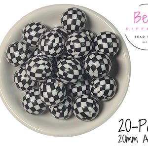 May include: A collection of black and white checkered acrylic beads, each 20mm in diameter, fills a white bowl. The beads have a glossy finish. The image includes the text "20-Pack 20mm Acrylic" and the logo for "Bead Different Bead Supply".
