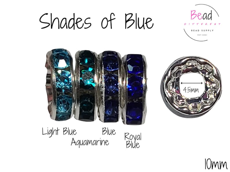May include: Four silver spacer beads with different shades of blue rhinestones. The beads are labeled "Light Blue", "Aquamarine", "Blue", and "Royal Blue". The beads are 10mm in diameter and have a 4.5mm hole.