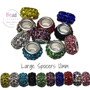 May include: A collection of round, 12mm rhinestone-encrusted metal spacer beads in various colors including yellow, blue, red, green, pink, purple, black, and clear. The beads feature a central hole and are arranged in a cluster and a single row.