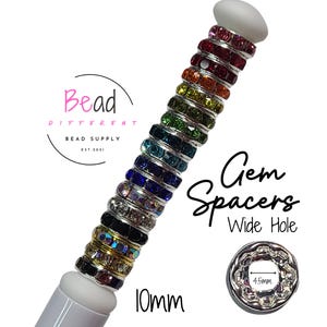May include: A collection of 10mm wide hole gem spacers in various colors. The spacers are made of metal and have a 4.5mm hole. The text "Gem Spacers Wide Hole" is written on a white background.