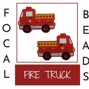 May include: Two red fire truck shaped plastic beads with black wheels and yellow details. The beads say "FIRE TRUCK" on a red banner.