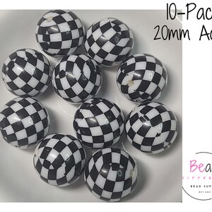 May include: A collection of ten 20mm acrylic beads with a black and white checkered pattern. The beads are spherical and displayed on a white surface. Text in the image reads "10-Pack 20mm Acrylic".