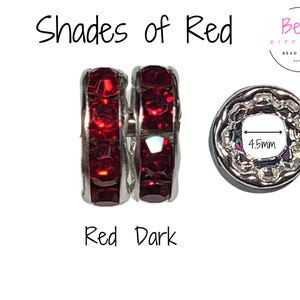 May include: Two silver spacer beads with dark red crystal accents. The beads are 10mm in diameter and have a 4.5mm hole. The beads are labeled "Shades of Red" and "Red Dark".