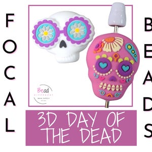 May include: Two 3D Day of the Dead focal beads. One is white with purple and blue flower-shaped glasses. The other is pink with colorful floral and heart details. The word "BEADS" is written vertically.