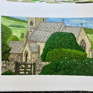 May include: Watercolour painting of a stone church with a green roof and a tall spire. The church is surrounded by lush green trees and bushes. The painting is done in a realistic style and captures the beauty of the church.