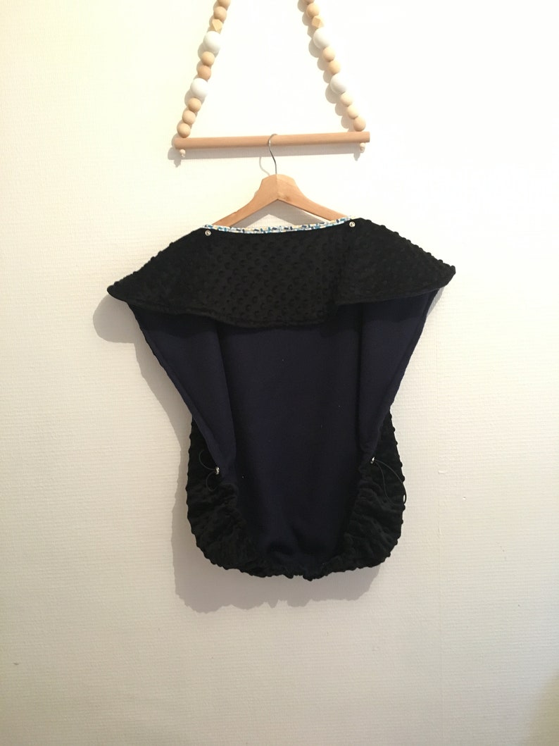 Baby carrying cape with wax key