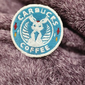 May include: A blue and white embroidered patch with the text "Starbucks Coffee" and a stylized mermaid logo.