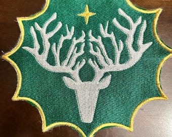 May include: An embroidered patch in green and yellow with a white deer silhouette and a gold star in the centre.