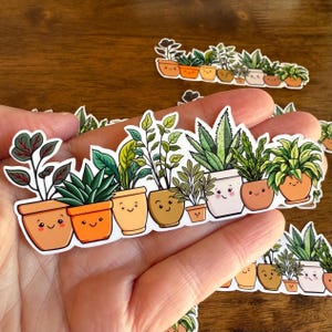 May include: A collection of plant stickers featuring various potted plants with smiling faces. The stickers showcase a range of greenery, including succulents and leafy plants, in terracotta and white pots. The design is a cute, cartoon style.