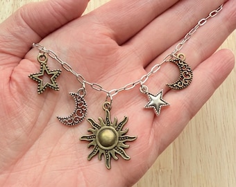 5 charm necklace with silver and brass moons, stars, and sun charms 18”