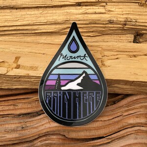 May include: A black and blue water drop sticker with a mountain scene and the text "Mount Rain Here".