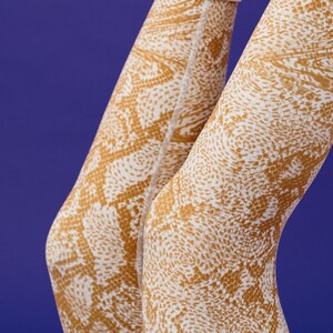 May include: A pair of beige tights with a brown snake skin pattern.