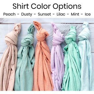 May include: Six folded t-shirts in different colors: peach, dusty green, sunset orange, lilac, mint green, and ice blue.  Shirt Color Options: Peach - Dusty - Sunset - Lilac - Mint - Ice