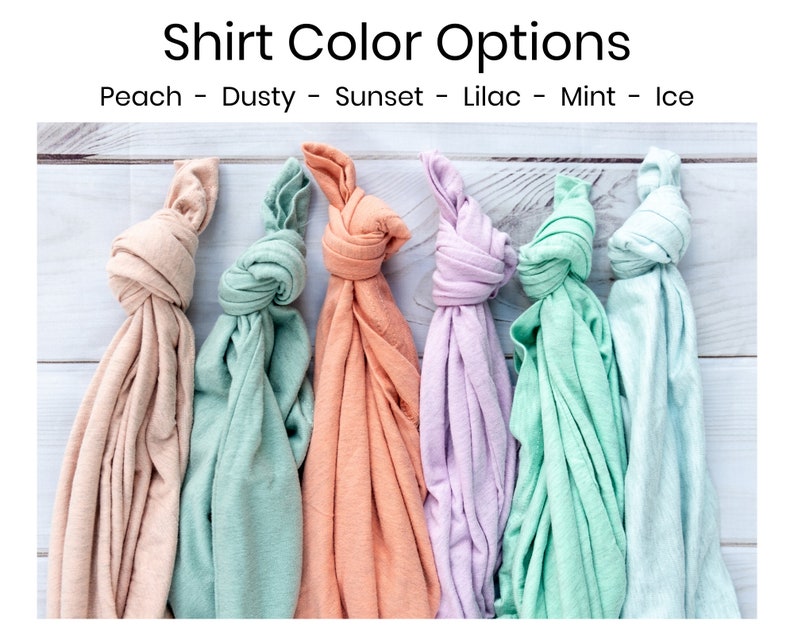 May include: Six folded t-shirts in different colors: peach, dusty green, sunset orange, lilac, mint green, and ice blue.  Shirt Color Options: Peach - Dusty - Sunset - Lilac - Mint - Ice
