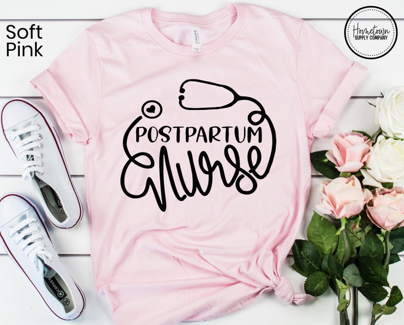 May include: A soft pink t-shirt with a black graphic that says "Postpartum Nurse" with a stethoscope and heart design.