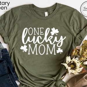 May include: A green t-shirt with the text "ONE lucky MOM" in white lettering and shamrock designs.