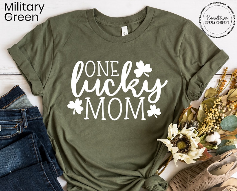 May include: A green t-shirt with the text "ONE lucky MOM" in white lettering and shamrock designs.