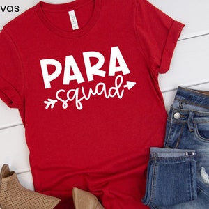 May include: Red t-shirt with white text that says "PARA squad" with an arrow pointing to the right.