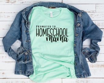 May include: A light green t-shirt with the text "Promoted to Homeschool Mama" in black lettering.