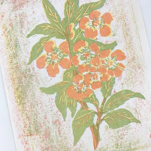 May include: A vintage print of a floral design featuring orange flowers with yellow centers and green leaves on a white background with a textured pattern.