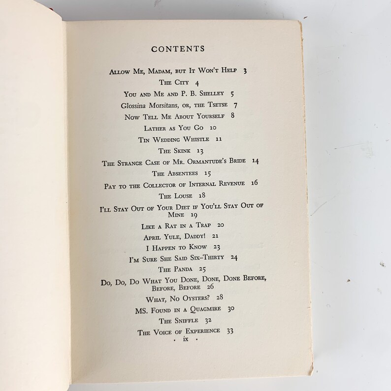 May include: A black and white book with the title "CONTENTS" printed in bold, followed by a list of short story titles and page numbers. The book is open to a page with the title "ALLOW ME, MADAM, BUT IT WON'T HELP" and the page number "3".