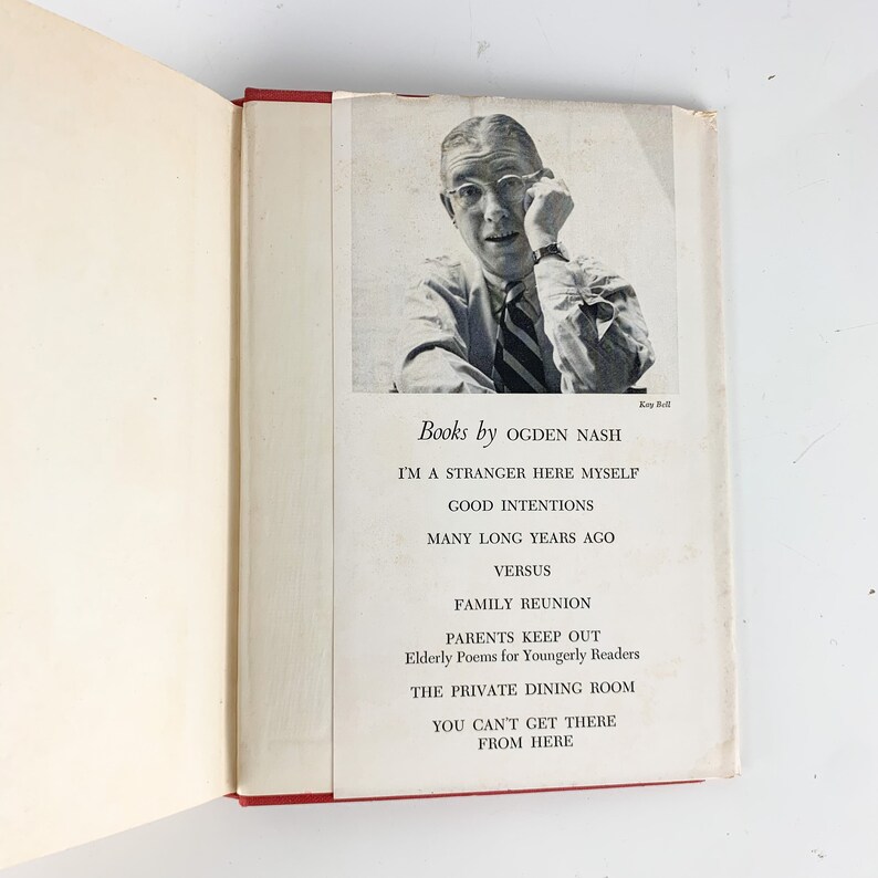 May include: A black and white photo of a man wearing glasses and a tie. The text below the photo reads "Books by Ogden Nash" and lists the titles of his books: "I'm a Stranger Here Myself", "Good Intentions", "Many Long Years Ago", "Versus", "Family Reunion", "Parents Keep Out", "Elderly Poems for Youngerly Readers", "The Private Dining Room", "You Can't Get There From Here".