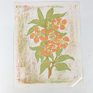 May include: A vintage print of a stylized orange flower with green leaves on a textured white background.