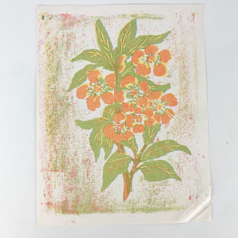 May include: A vintage print of a stylized orange flower with green leaves on a textured white background.
