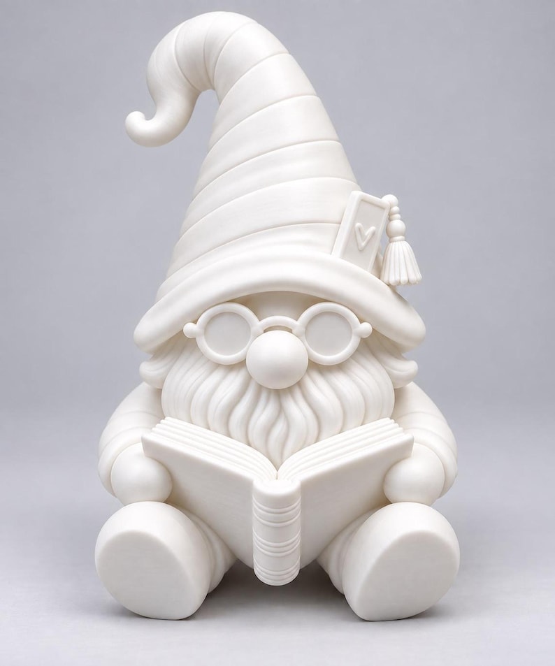 Front view of the white unpainted gnome figurine holding an open book, wearing a pointed hat with a tassel and round glasses, against a plain gray background.