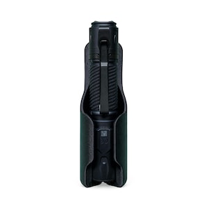 May include: A black flashlight with a textured grip is held in a dark green leather case. The flashlight has a metal clip and a button at the base. The case has a soft, felt-like interior.