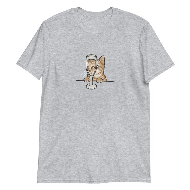 May include: A gray t-shirt with a cartoon image of a cat peeking over a champagne glass.