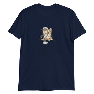 May include: A navy blue t-shirt with a graphic of a cat peeking out from behind a champagne glass.