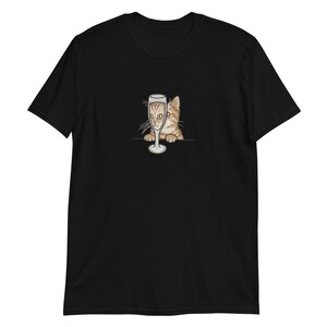 May include: A black t-shirt with a graphic of a cat peeking out of a champagne glass.